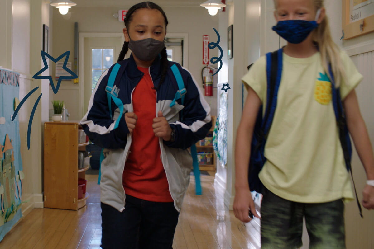Children in masks walking in the hallway